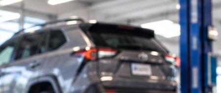 A car on the lift in a mechanic shop bay